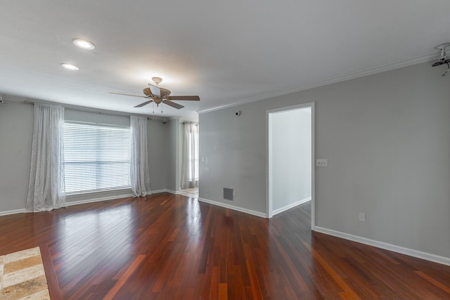spare room featuring crown molding, wood finished floors, ceiling fan, and baseboards