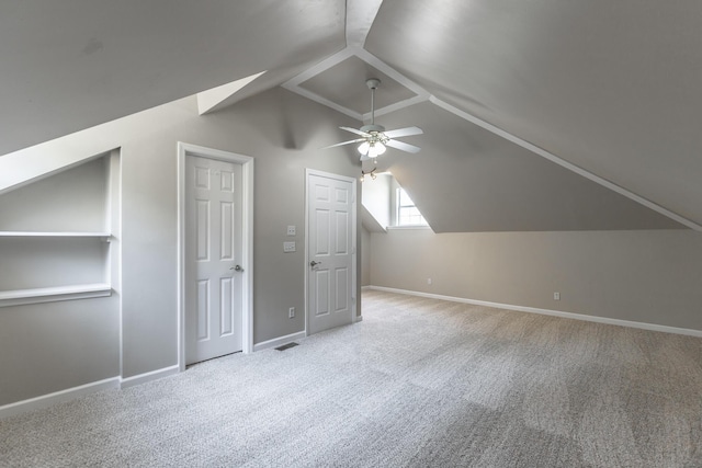 bonus room featuring carpet, baseboards, vaulted ceiling, and a ceiling fan