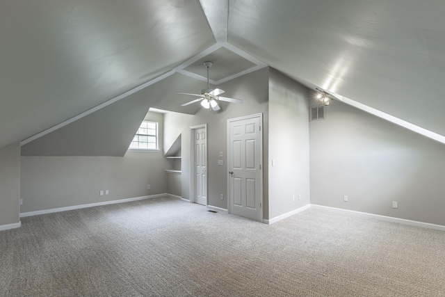 bonus room with ceiling fan, vaulted ceiling, carpet flooring, and visible vents
