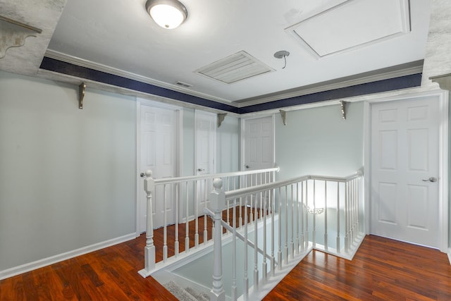 interior space featuring visible vents, an upstairs landing, and wood finished floors