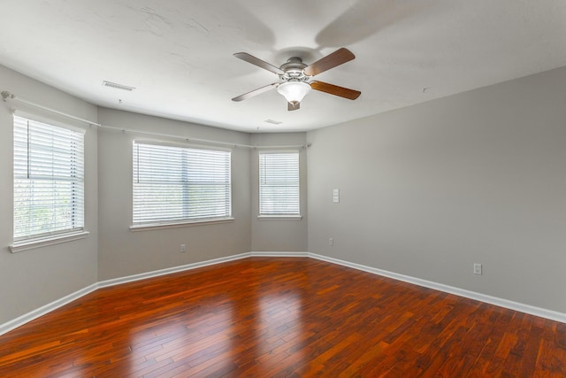 spare room with ceiling fan, baseboards, and plenty of natural light