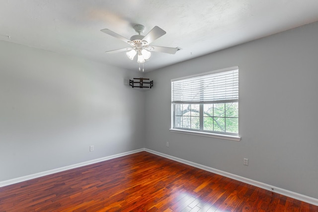 unfurnished room with hardwood / wood-style flooring, baseboards, and a ceiling fan