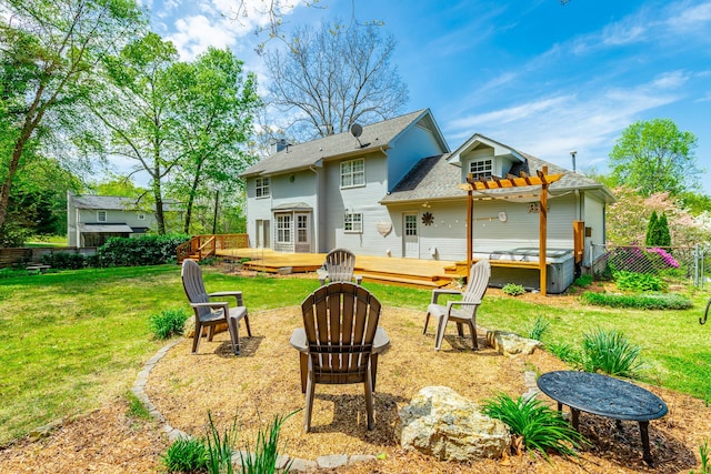 rear view of property with a pergola, a yard, an outdoor fire pit, fence, and a wooden deck