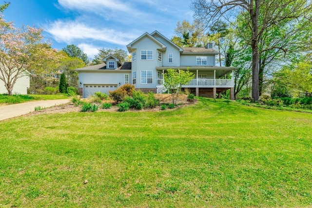 view of front of home with a porch, a front lawn, an attached garage, a chimney, and concrete driveway