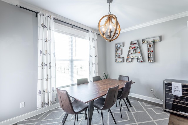 dining area featuring wine cooler, baseboards, a notable chandelier, and ornamental molding