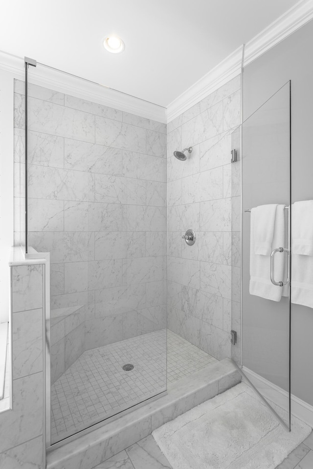 bathroom featuring marble finish floor, recessed lighting, ornamental molding, and a stall shower