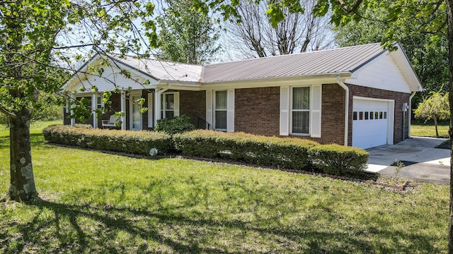 ranch-style house with concrete driveway, an attached garage, a front yard, metal roof, and brick siding