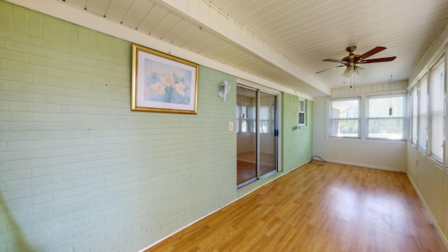 unfurnished sunroom featuring ceiling fan