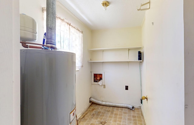 washroom featuring water heater, a textured ceiling, laundry area, and washer hookup