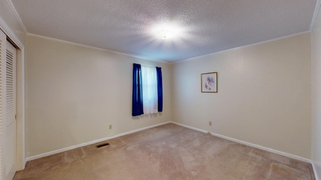 unfurnished bedroom featuring visible vents, baseboards, light colored carpet, a closet, and ornamental molding