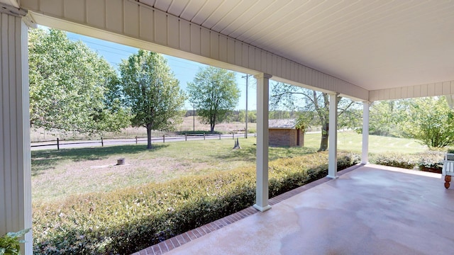 view of patio with an outbuilding and fence