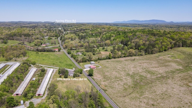 birds eye view of property with a wooded view and a mountain view