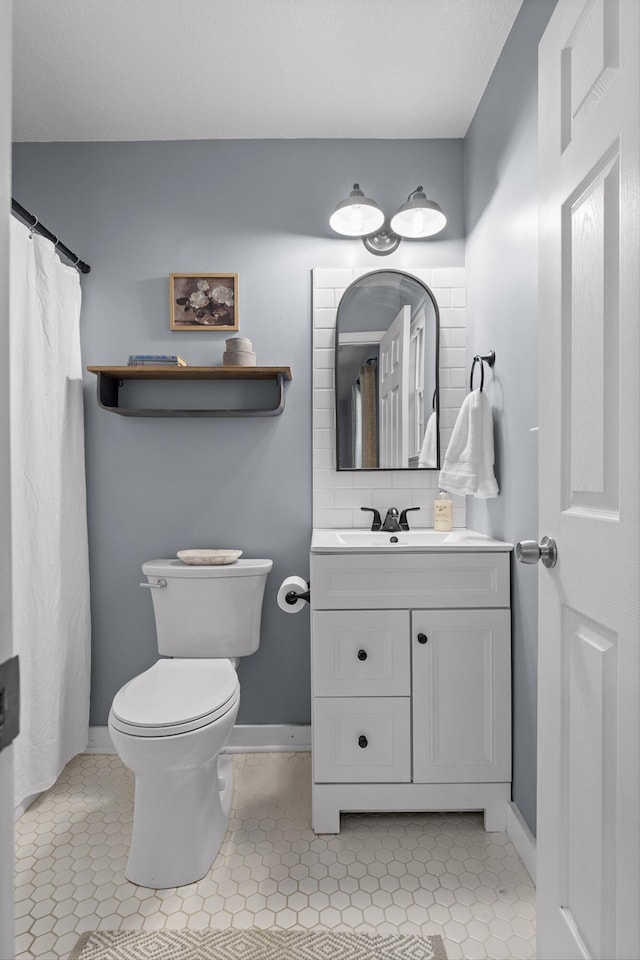 full bathroom featuring tile patterned floors, toilet, and vanity
