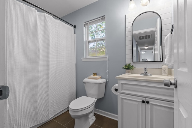 full bathroom with vanity, toilet, visible vents, baseboards, and tile patterned flooring