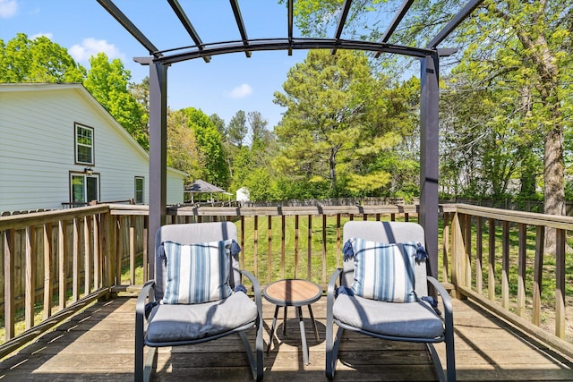 wooden deck featuring fence and a pergola