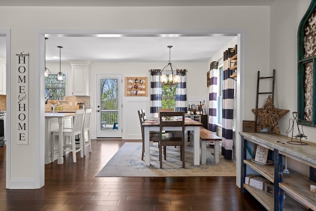dining area featuring a chandelier and dark wood-style flooring