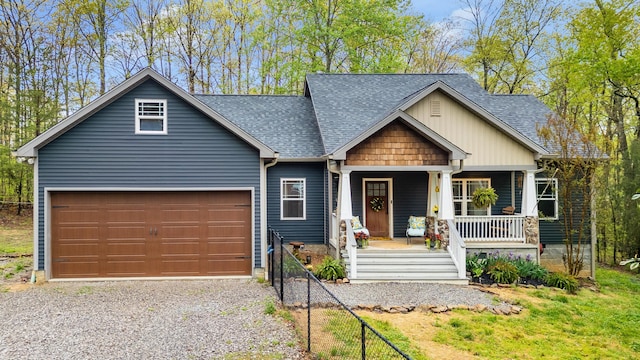 craftsman inspired home with fence, a porch, a shingled roof, and driveway