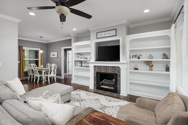 living room with dark wood-style floors, recessed lighting, ornamental molding, and a ceiling fan