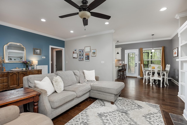 living room featuring ornamental molding, a ceiling fan, and dark wood-type flooring
