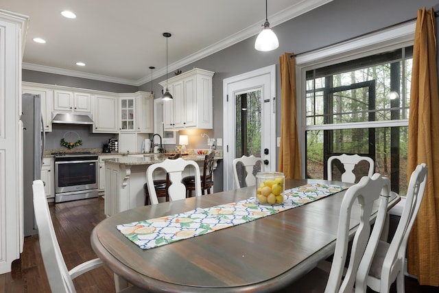 dining space with recessed lighting, ornamental molding, and dark wood finished floors