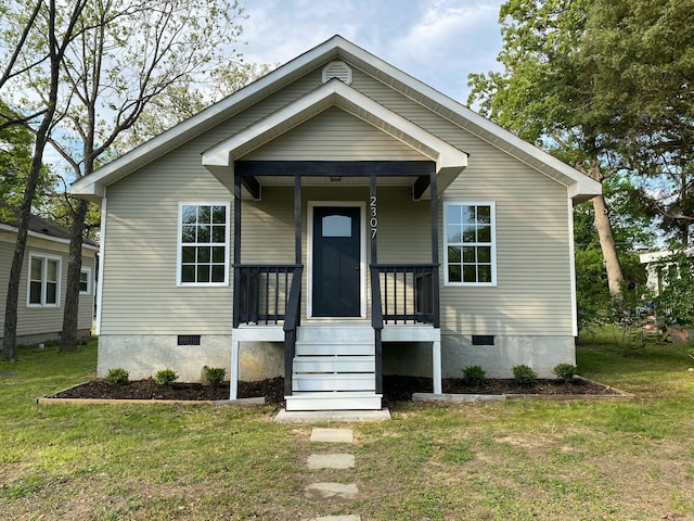 bungalow-style home featuring a porch, crawl space, and a front lawn