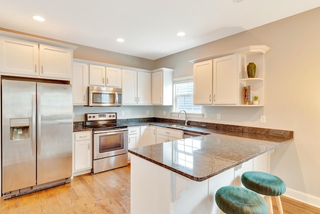 114 W 19th St, Chattanooga, TN 37408 - kitchen featuring a sink, white cabinetry, a peninsula, open shelves, and stainless steel appliances