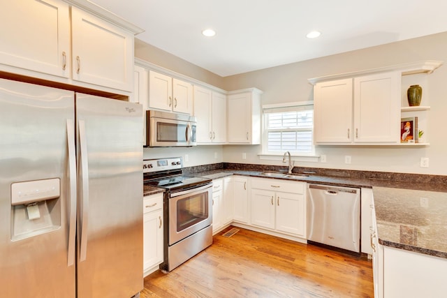 114 W 19th St, Chattanooga, TN 37408 - kitchen featuring a sink, white cabinets, open shelves, stainless steel appliances, and dark stone counters