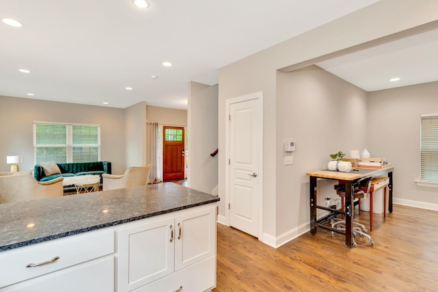 114 W 19th St, Chattanooga, TN 37408 - kitchen featuring baseboards, light wood-style flooring, dark stone countertops, and white cabinets