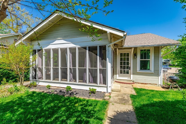 915 Barton Ave, Chattanooga, TN 37405 - back of house featuring a yard, a shingled roof, and a sunroom
