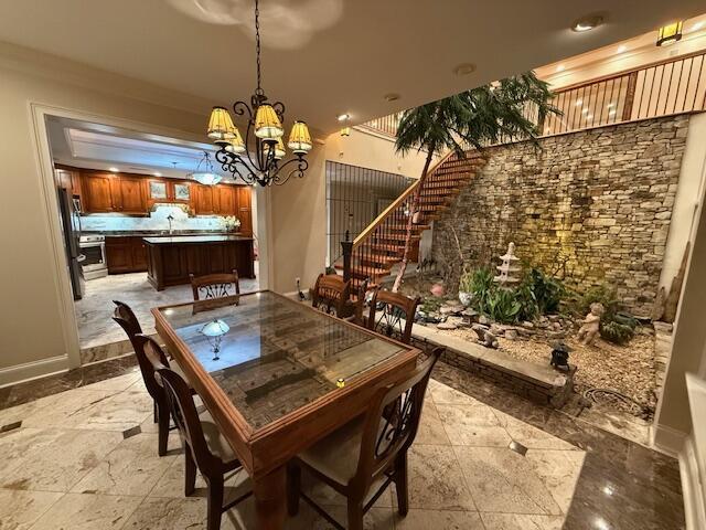 dining space with a chandelier and baseboards