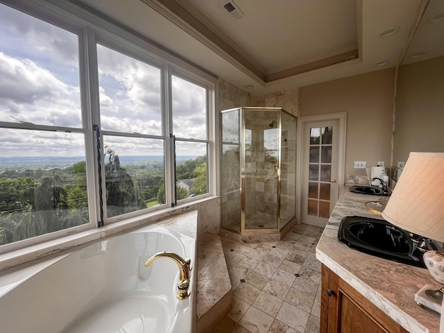 bathroom with a shower stall, a bath, double vanity, and crown molding