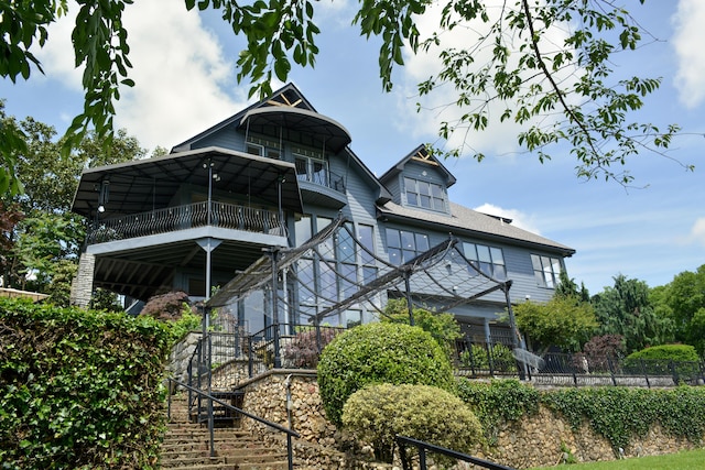 rear view of property with stairs and fence
