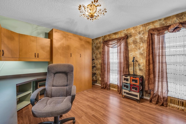 6434 Waconda Point Rd, Harrison, TN 37341 - office featuring a textured ceiling, wallpapered walls, light wood finished floors, and baseboards