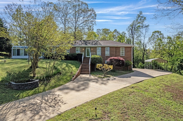 6434 Waconda Point Rd, Harrison, TN 37341 - ranch-style home featuring concrete driveway, a carport, a front lawn, brick siding, and a sunroom