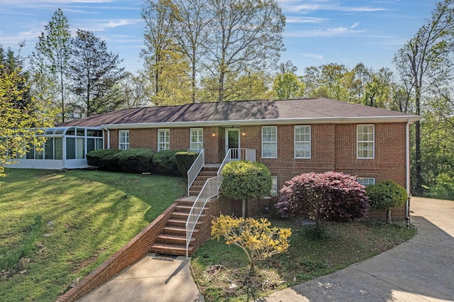 6434 Waconda Point Rd, Harrison, TN 37341 - ranch-style house with brick siding, a front yard, stairway, and a sunroom