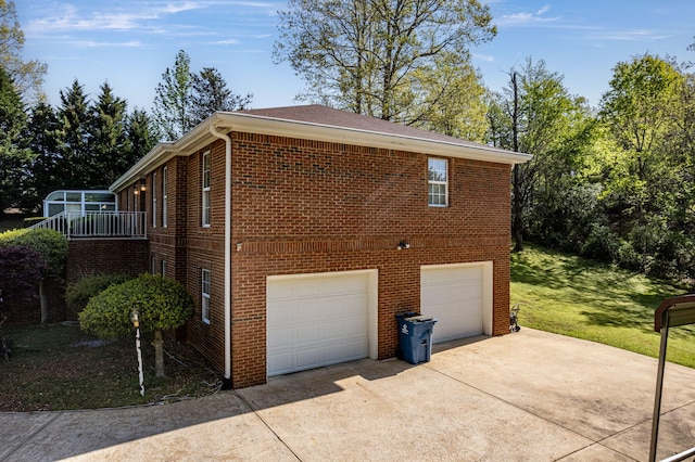 6434 Waconda Point Rd, Harrison, TN 37341 - view of home's exterior featuring brick siding, an attached garage, a lawn, and concrete driveway