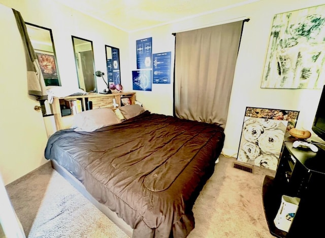 bedroom with visible vents and carpet