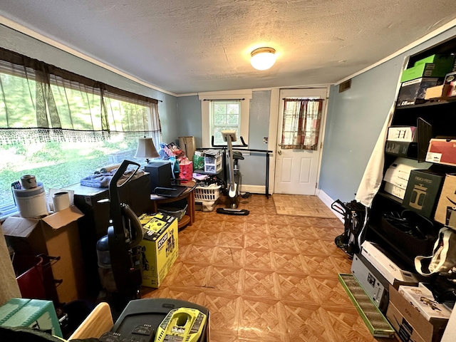workout room with visible vents, a textured ceiling, and ornamental molding