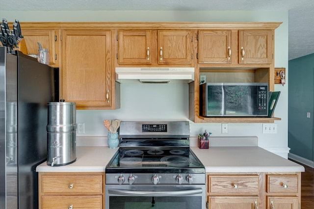 kitchen featuring light countertops, appliances with stainless steel finishes, and under cabinet range hood