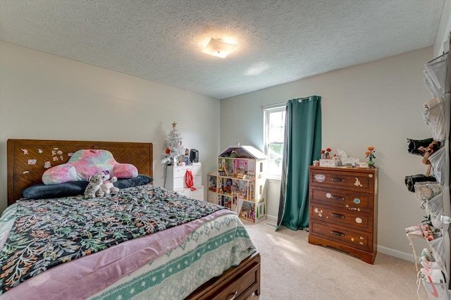 bedroom featuring a textured ceiling, baseboards, and light carpet