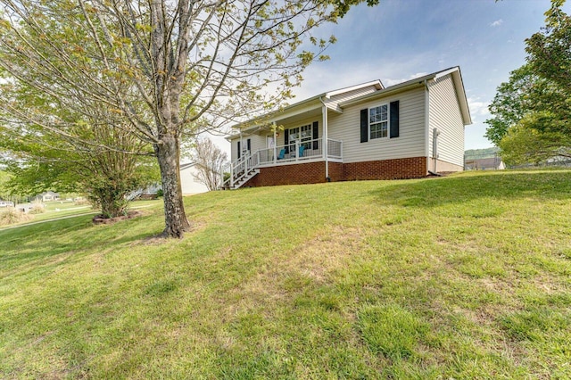 single story home featuring covered porch and a front yard