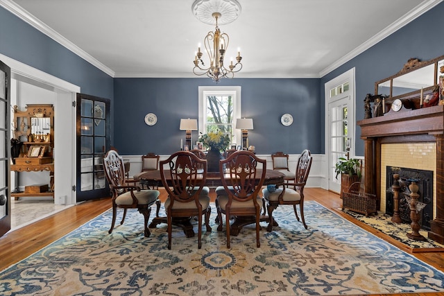 302 S Main St, Lafayette, GA 30728 - dining room with a tile fireplace, crown molding, a chandelier, and wood finished floors