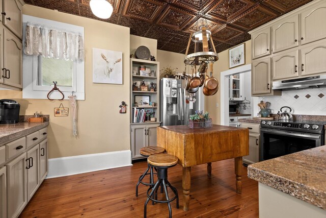 302 S Main St, Lafayette, GA 30728 - kitchen with an ornate ceiling, decorative backsplash, under cabinet range hood, dark wood-type flooring, and appliances with stainless steel finishes