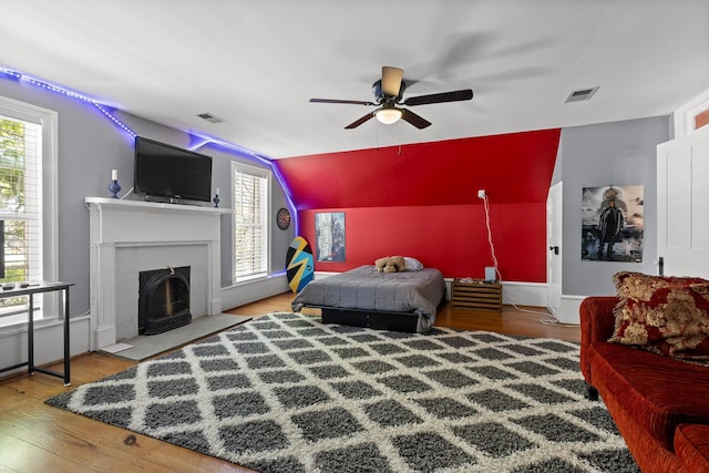 302 S Main St, Lafayette, GA 30728 - bedroom featuring a fireplace with flush hearth, lofted ceiling, wood finished floors, and visible vents