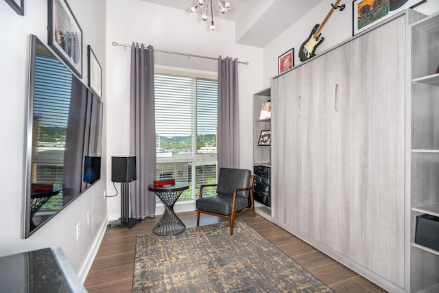 living area featuring baseboards and wood finished floors
