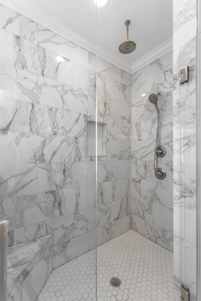 bathroom featuring crown molding and a stall shower