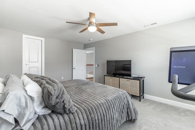 carpeted bedroom featuring baseboards, a ceiling fan, and visible vents