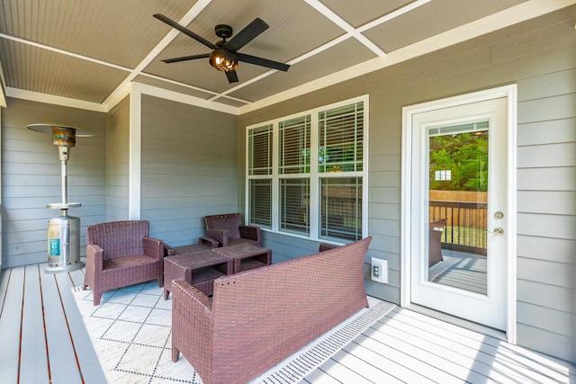 wooden terrace featuring a ceiling fan and an outdoor living space
