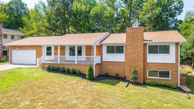 single story home featuring a front yard, covered porch, a garage, and concrete driveway