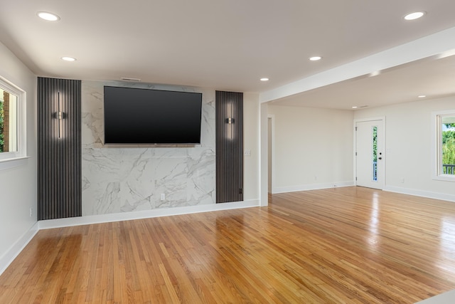 unfurnished living room featuring light wood-style flooring, recessed lighting, and baseboards